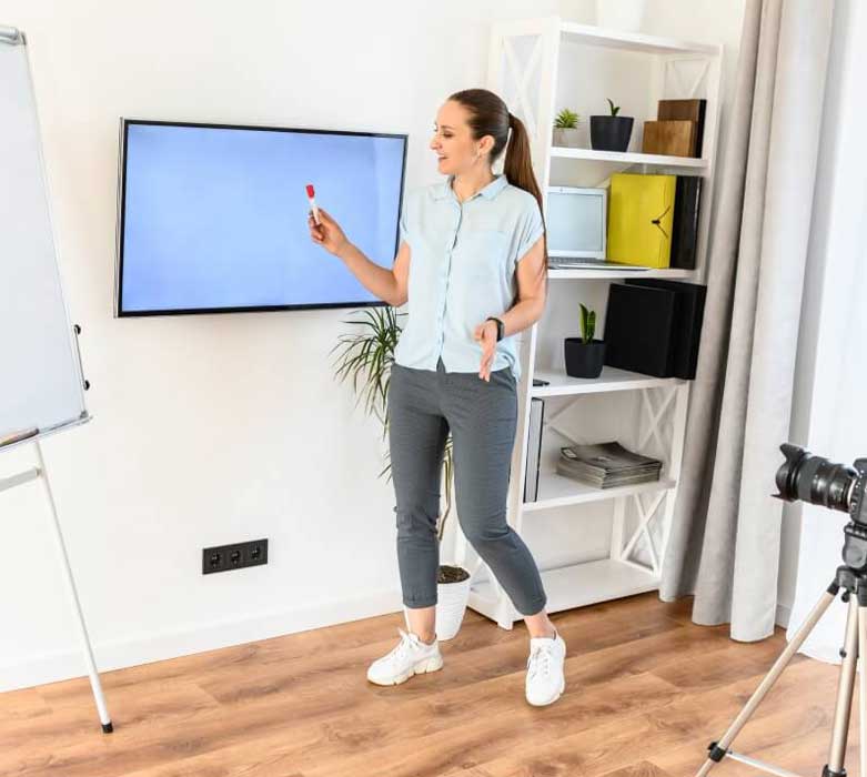 Woman pointing on a tv screen in a room