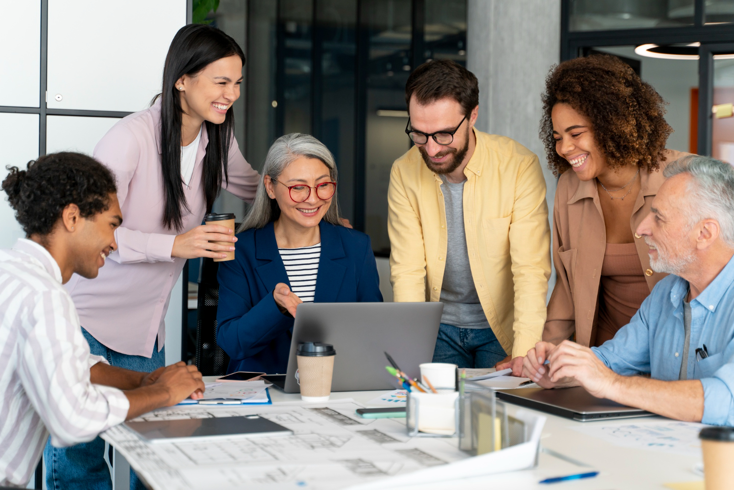 Photo showing employees of different ages, including Boomers, Gen X, Millennials, and Gen-Z. This represents the importance of training a multigenerational workforce.