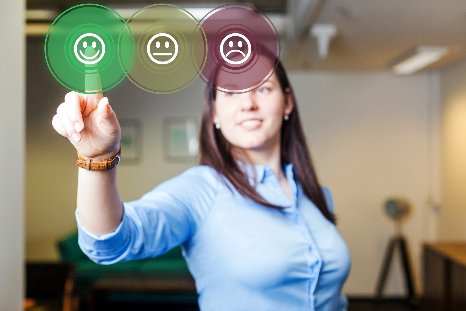 Woman selecting a happy face icon on a virtual feedback screen, symbolizing positive customer experience and the essential skills needed for customer service.