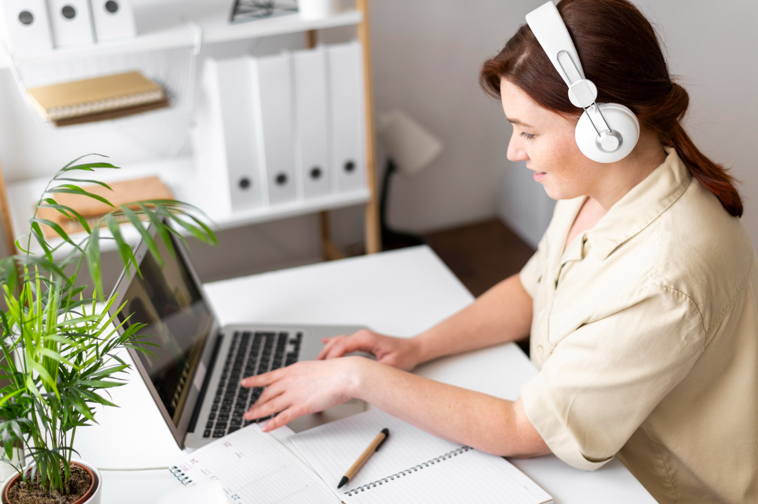 A woman completing training on a laptop, signifying the importance of online learning platforms for business and individuals.
